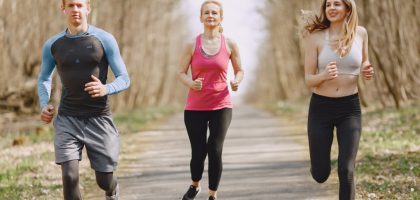 Three adults jogging on a park path, embracing a healthy and active lifestyle.
