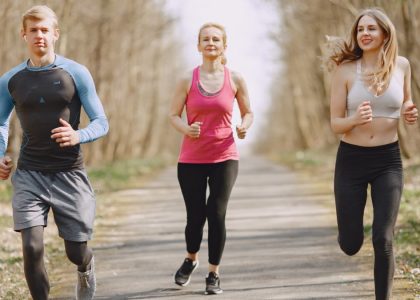 Three adults jogging on a park path, embracing a healthy and active lifestyle.